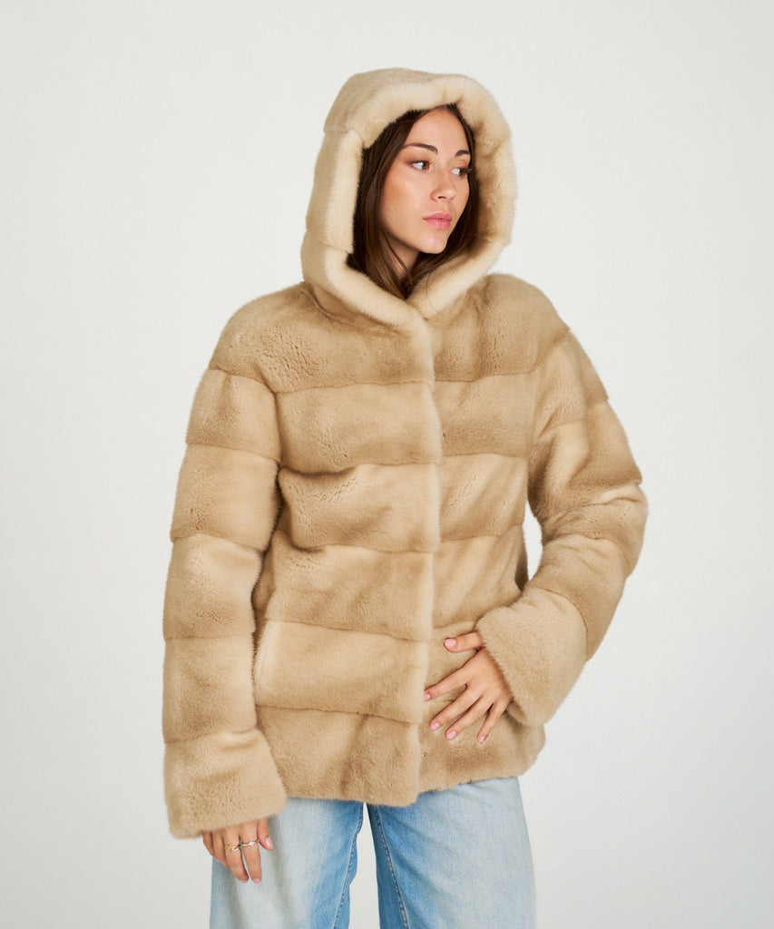 Cazadora de visón en color arena. Piel natural de alta calidad con capucha y cierre oculto. Elegancia, suavidad y calidez en una prenda exclusiva.
