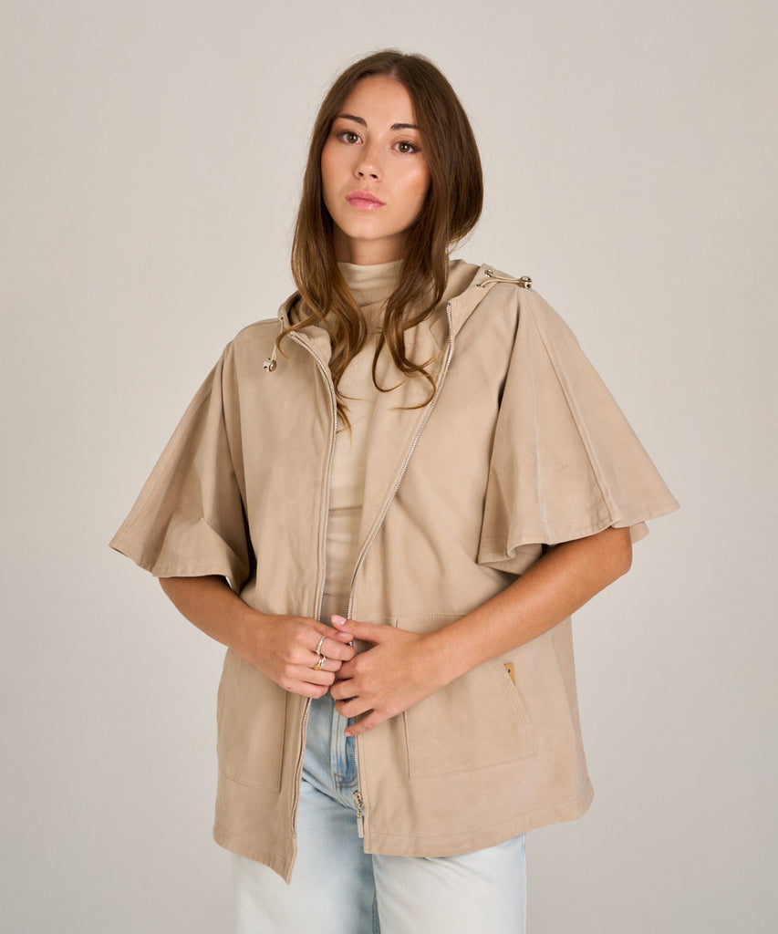 Chaqueta de ante color arena con capucha y manga corta. Diseño relajado, suave y versátil, perfecta para entretiempo.